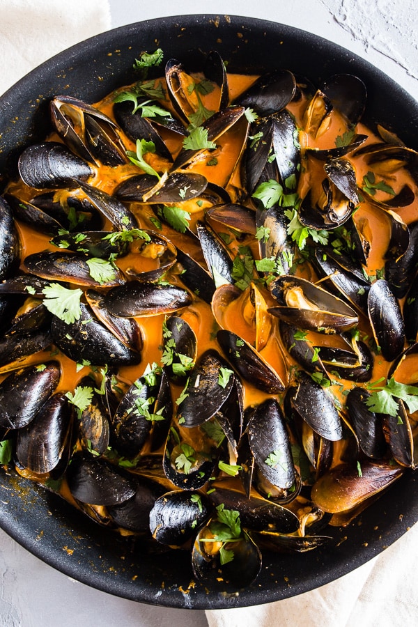 These red curry coconut milk mussels are ready in just 35 minutes and are packed full of ginger, garlic, and lemongrass flavors. You'll be blown away by how easy they are to make and want to sop up every last drop of the red curry coconut milk sauce!