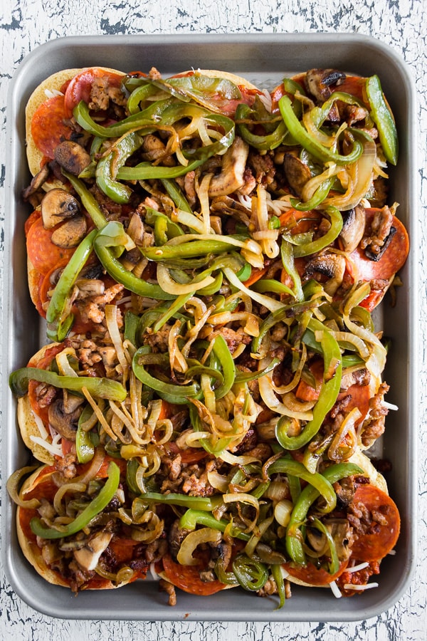 These baked supreme pizza sliders are the new baked sandwiches of your dreams. They taste just like loaded supreme pizza made with marinara sauce, spicy Italian sausage, pepperoni, mushrooms, green peppers, onions and lots of mozzarella cheese. You'll love how easy these baked sliders are to make! 