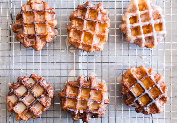 These apple butter waffle donuts are the perfect sweet Easter brunch treat. Perfectly spiced apple butter waffles fried to donut perfection and dipped in a vanilla bean glaze. You'll love these sweet little donut treats.