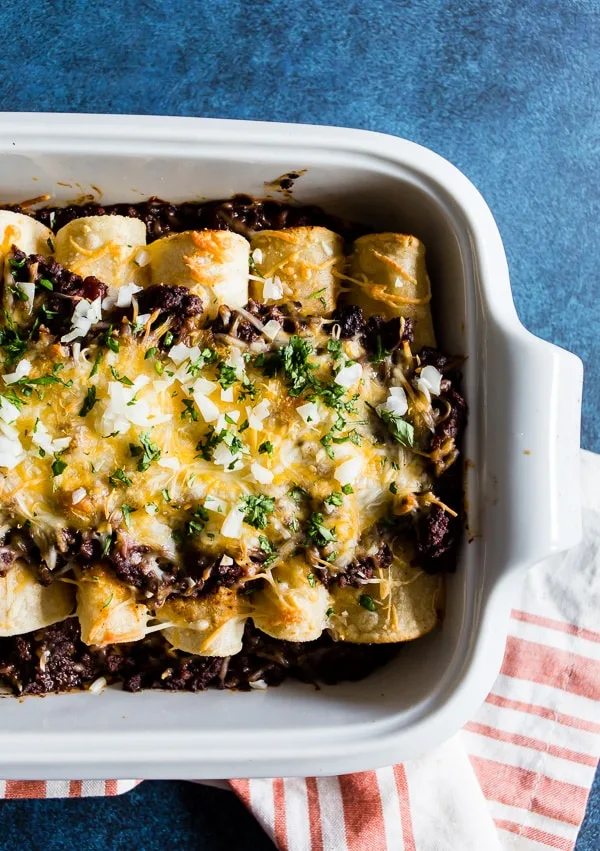 These chipotle beef enchiladas are made with homemade chipotle beef chili and rolled up in corn tortillas and covered with cheddar cheese. The best part is you can make the chili days before making to help cut down on prep time. If you have never made enchiladas before now is the time!