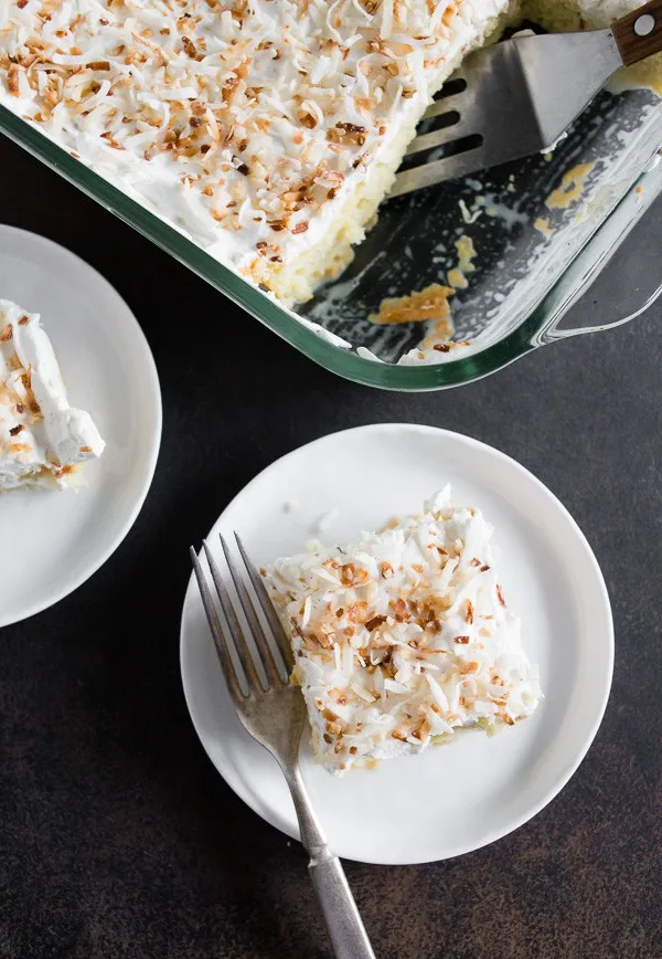 Toasted Coconut Tres Leches Cake in 2 plates and in a pan. 