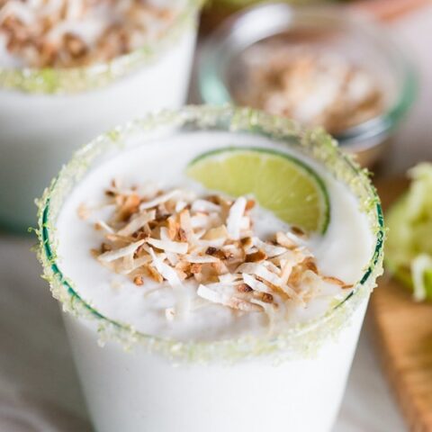 This coconut lime frozen margarita is just what your summer ordered! PACKED full of sweet coconut flavor and jazzed up with zippy lime juice. Instead of salt, I opted to rim the cocktail with lime sugar and top it with toasted coconut.