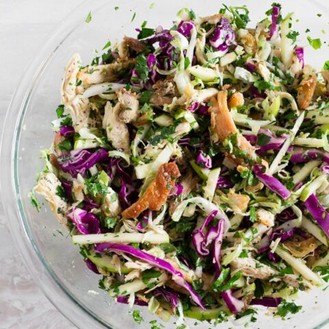 This crispy chicken apple cabbage salad is guaranteed to be your new favorite salad. It's made super easy by using rotisserie chicken and crisping it up in olive oil with lemongrass, ginger, and garlic. That's combined with lots of fresh chopped cabbage, minced herbs, apples and a light squeeze of lime.
