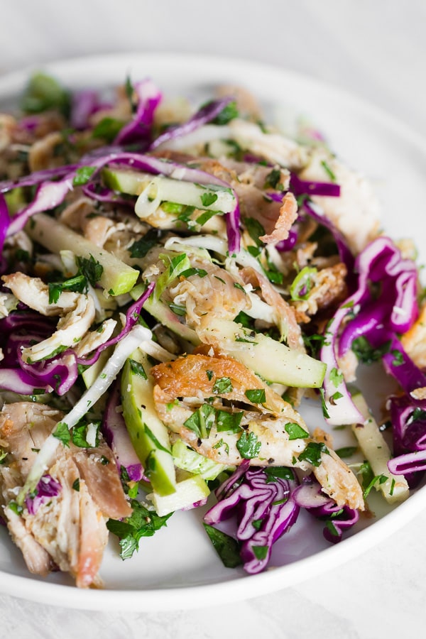 This crispy chicken apple cabbage salad is guaranteed to be your new favorite salad. It's made super easy by using rotisserie chicken and crisping it up in olive oil with lemongrass, ginger, and garlic. That's combined with lots of fresh chopped cabbage, minced herbs, apples and a light squeeze of lime. 