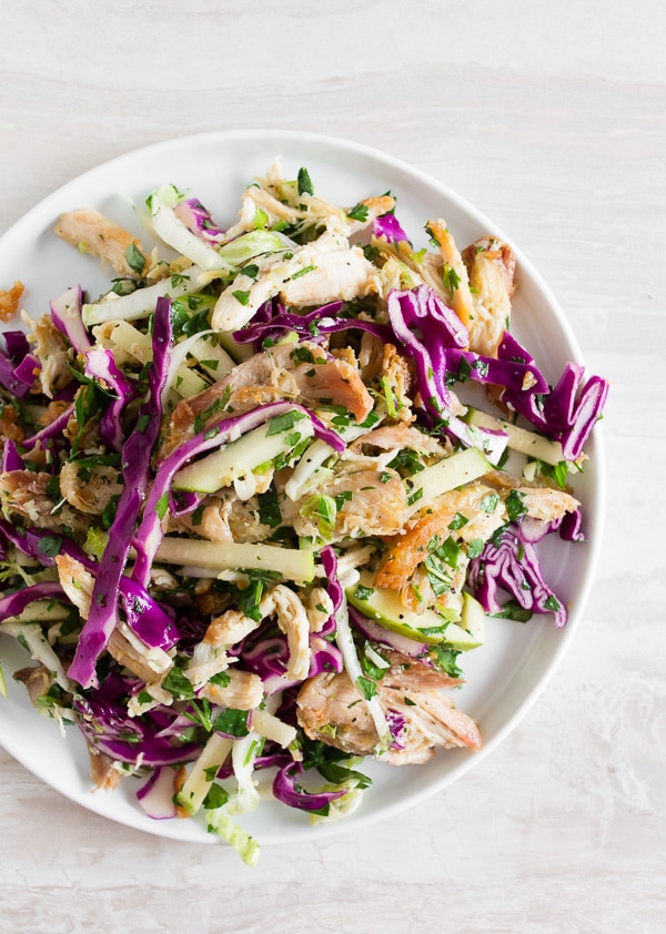 This crispy chicken apple cabbage salad is guaranteed to be your new favorite salad. It's made super easy by using rotisserie chicken and crisping it up in olive oil with lemongrass, ginger, and garlic. That's combined with lots of fresh chopped cabbage, minced herbs, apples and a light squeeze of lime. 