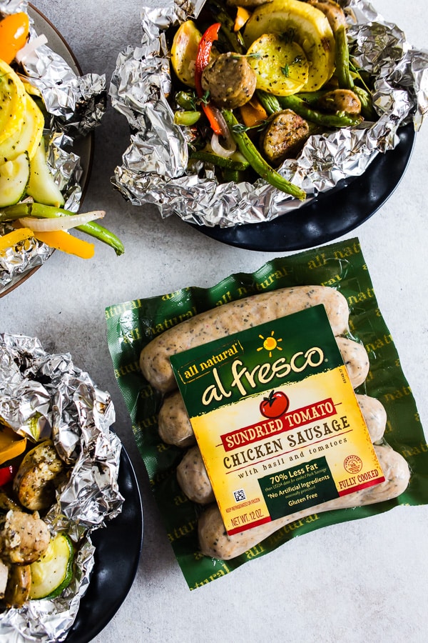 This chicken sausage and vegetable foil packet dinner is super simple to make and perfect for summer. Packed full of chicken sausage, sweet peppers, zucchini, yellow squash, red onion, green beans and drizzled with a herbed olive oil. You'll love this simple dinnertime recipe!