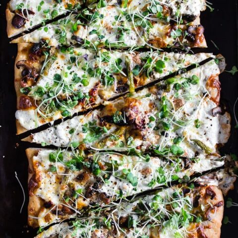 This asparagus mushroom burrata pizza cooks up in less than 20 minutes and is the perfect spring pizza. Topped with lots of sauteed mushrooms, asparagus, sun-dried tomatoes, mozzarella cheese, burrata cheese and sprinkled with red pepper flakes and micro greens. You'll LOVE this pie!