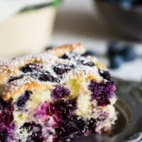 This blueberry lemon ricotta olive oil cake is the perfect snacking cake. Sprinkled with a little powdered sugar and perfect for breakfast or dessert! Plus the cake is super moist and crazy easy to make! You'll want to get into the kitchen and make this cake asap!