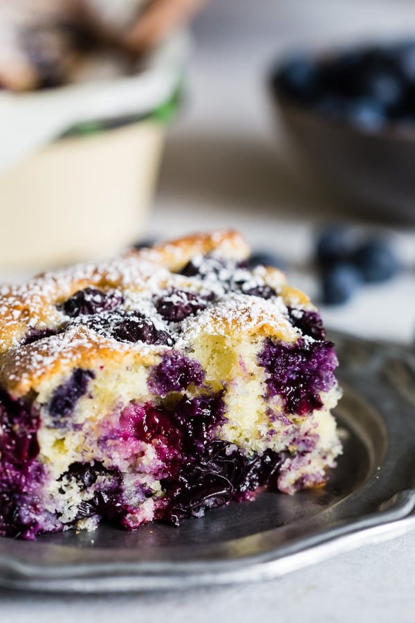 This blueberry lemon ricotta olive oil cake is the perfect snacking cake. Sprinkled with a little powdered sugar and great for breakfast or dessert! Plus the cake is super moist and crazy easy to make! You'll want to get into the kitchen and make this cake asap! 