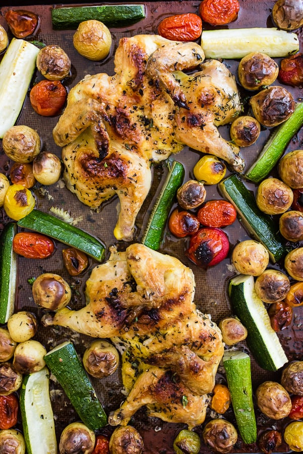 This sheet pan spatchcocked Cornish hens with summer vegetables is the perfect weeknight dinner. It all bakes up on one sheet pan and is packed with perfectly crisp Cornish hens, zucchini, baby potatoes and cherry tomatoes all tossed in an olive oil, oregano, thyme mixture. You'll love this sheet pan meal!