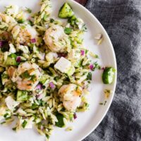This herbed shrimp orzo salad is packed full of lemon flavor, fresh herbs, cucumbers, red onion, salty feta and perfectly cooked garlic shrimp. This pasta salad is super easy to make and makes a great light summer meal or flavorful side dish.