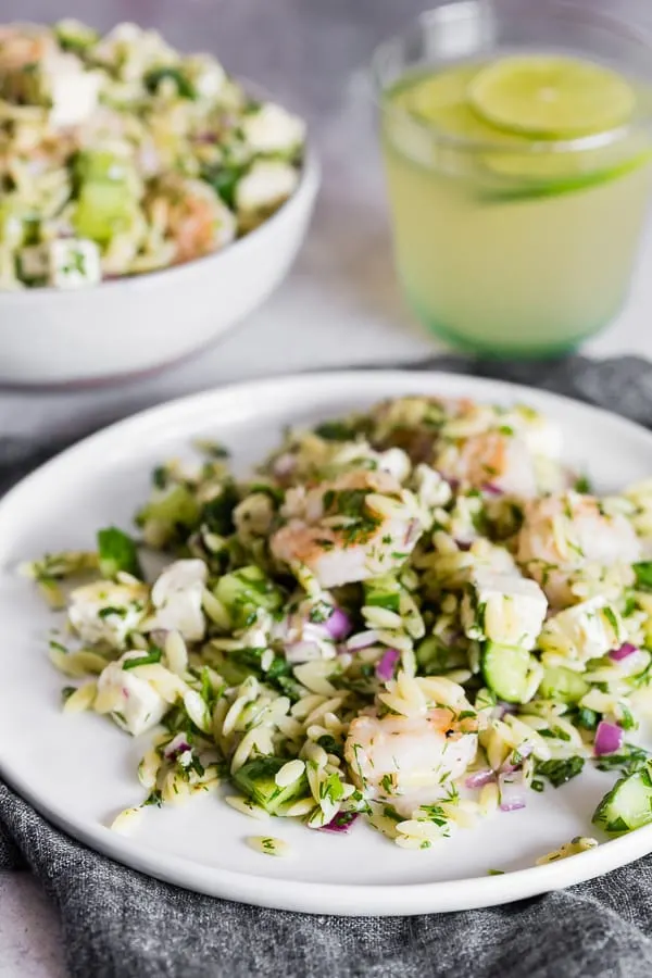 Herbed Shrimp Orzo Salad served with lemonade on a plate. 