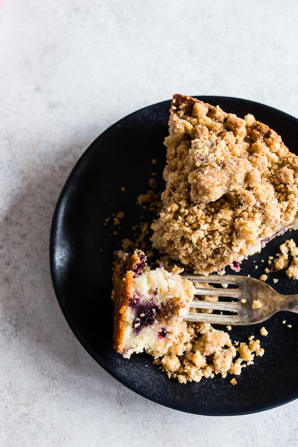 This mixed berry coffee cake is perfect for breakfast or dessert. Tender cake made with Greek yogurt, filled with fresh picked black raspberries and blackberries and topped with a crunchy brown sugar crumbly topping. This cake is perfect for summer!