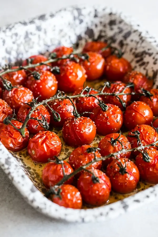 These on the vine roasted tomatoes are the packed full of flavor and the perfect use for all your summer tomatoes. Perfectly roasted and great on salads, thrown in pasta or just eaten plain. So simple and easy to make!