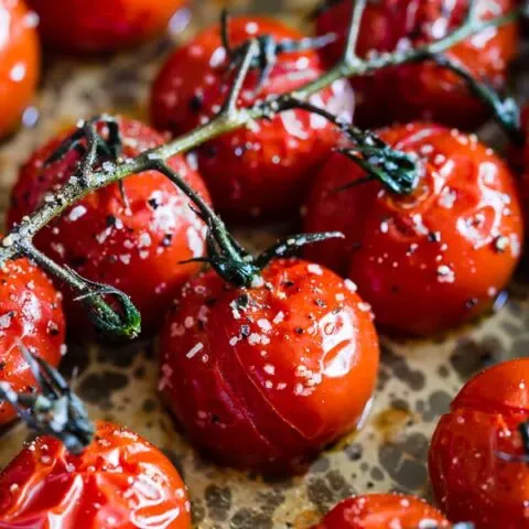 These on the vine roasted tomatoes are the packed full of flavor and the perfect use for all your summer tomatoes. Perfectly roasted and great on salads, thrown in pasta or just eaten plain. So simple and easy to make!