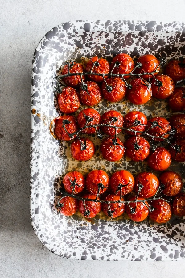 a tray full of on the vine roasted tomatoes