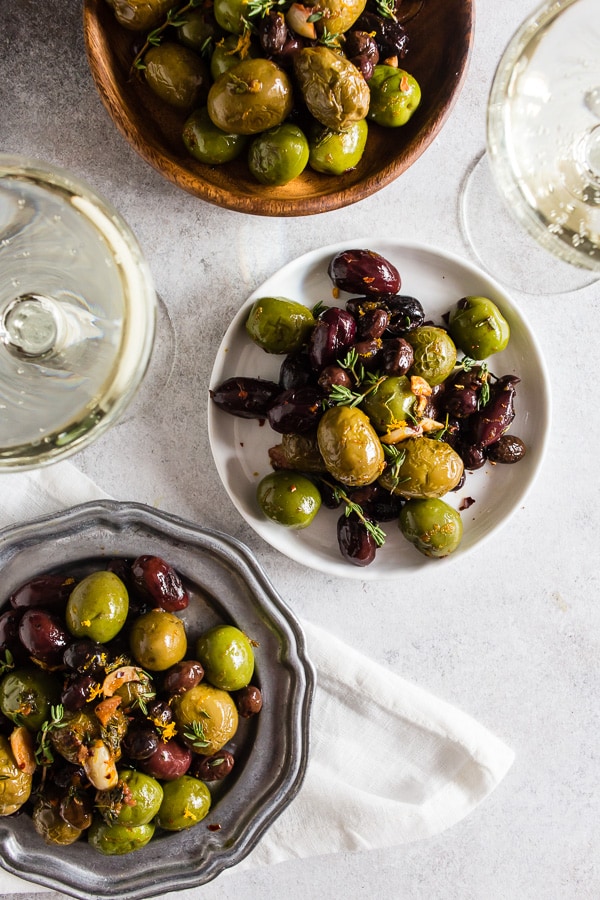These garlic herb roasted olives are the perfect snack food! They are salty, packed full of garlic, thyme and orange flavor and are ready in just 15 minutes! They pair perfectly with prosecco and will be sure to impress all the olive lovers in your life.