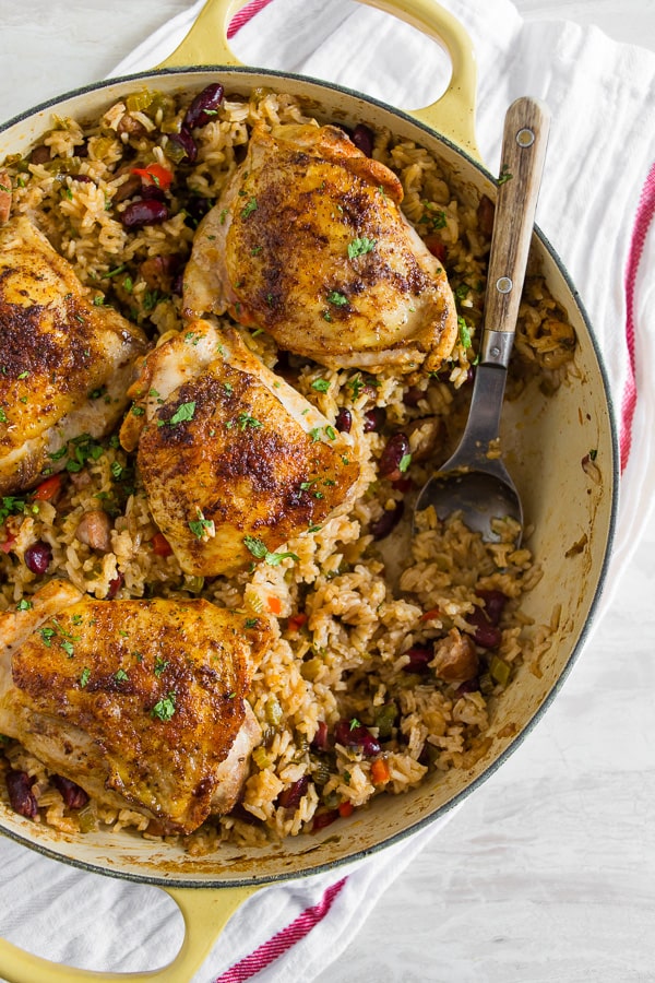 This one pot Cajun chicken and rice is the perfect fall meal. Packed full of flavor and prepared all in one pot. Crispy roast Cajun spiced chicken thighs on top of seasoned rice packed with Andouille sausage and red kidney beans. You’ll love how easy it is to throw together and clean up is a breeze.