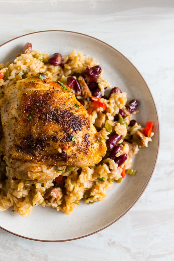 This one pot Cajun chicken and rice is the perfect fall meal. Packed full of flavor and prepared all in one pot. Crispy roast Cajun spiced chicken thighs on top of seasoned rice packed with Andouille sausage and red kidney beans. You’ll love how easy it is to throw together and clean up is a breeze.
