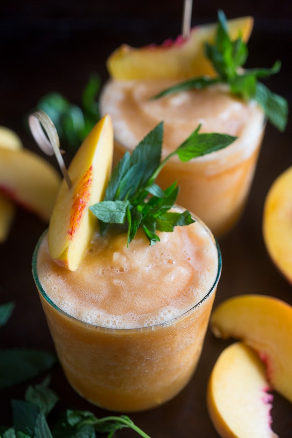These peach tea bourbon slushies are the perfect summer addition. Full of peach tea, bourbon and lots of fresh peaches. This cocktail is summer perfection!