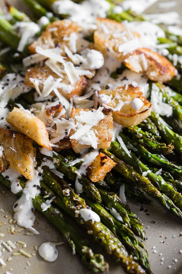This roasted asparagus Caesar salad is packed full of flavor and a great twist to classic roast asparagus. Plus you'll love the homemade Greek yogurt caesar dressing! 