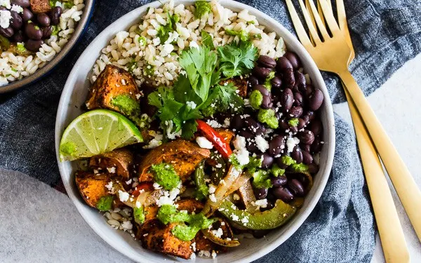 Sweet Potato Black Bean Burrito Bowls served in a bowl with a fork. 
