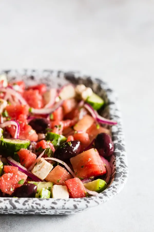Watermelon Greek Salad served with black olives. 