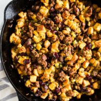 This potato bread sausage cranberry stuffing is the perfect addition to your Thanksgiving table. Made with soft potato bread, Italian sausage, tons of fresh herbs and dried cranberries. You'll love how easy this is to throw together and how delicious it tastes! 
