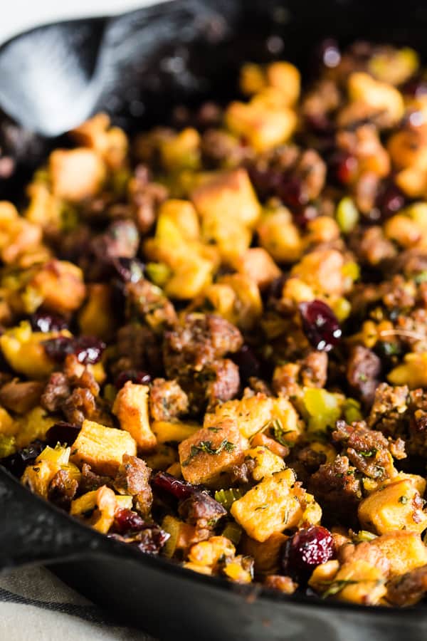 Potato Bread Sausage Cranberry Stuffing in a skillet on a table. 