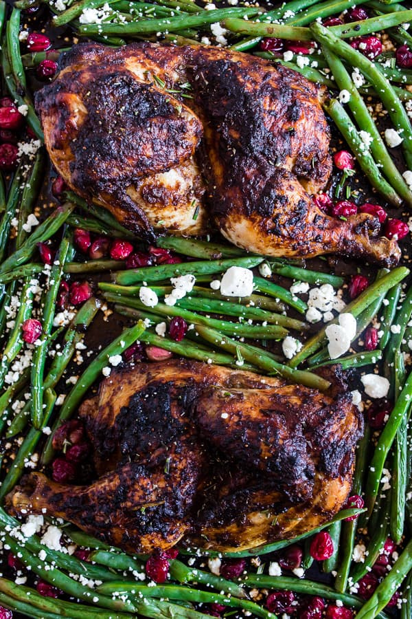 This sheet pan cranberry balsamic chicken and green beans is the perfect holiday meal for two. Chicken halves marinated in a cranberry balsamic sauce and served with roasted green beans, fresh cranberries, and goat cheese. 
