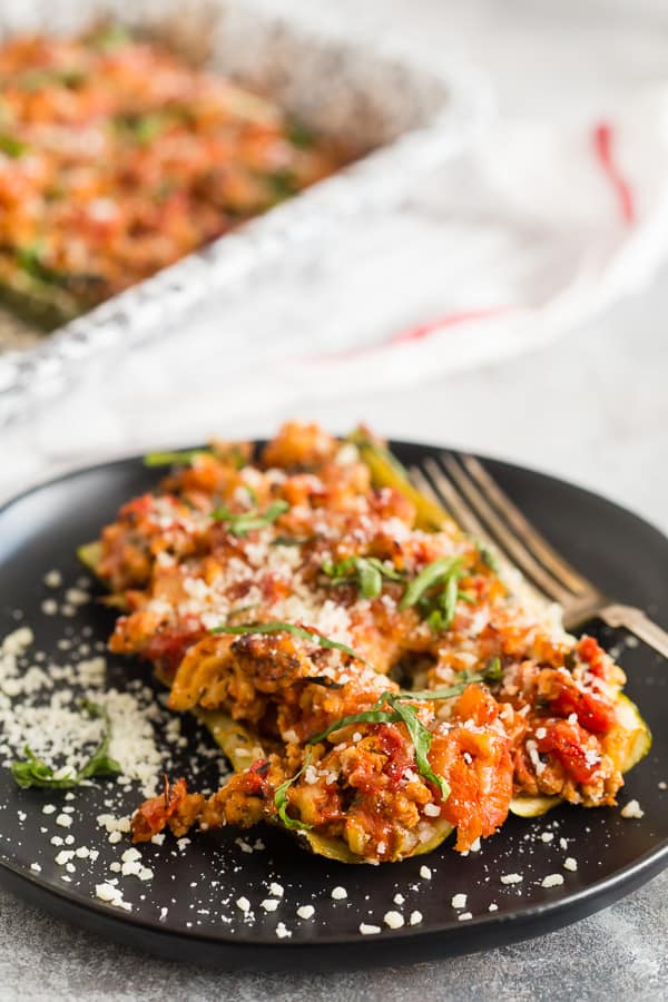 These stuffed zucchini boats are packed full of Italian flavor and super easy to make. Made with ground chicken, fresh basil, Italian seasoning and diced tomatoes all stuffed into zucchini boats and topped with mozzarella cheese. These are the perfect weeknight meal! 