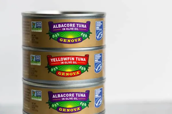 Stacked cans of unopened tuna in olive oil. 