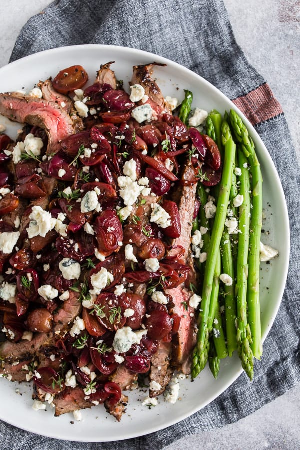 This grape and blue cheese flank steak is the perfect romantic meal and it's ready in JUST 30 minutes! Herb marinated flank steak cooked on the stovetop and topped with balsamic sautéed grapes and shallots and sprinkled with blue cheese - what's not to love? 