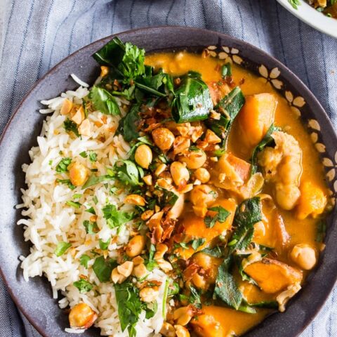 This African chicken peanut stew is packed full of chicken thighs, sweet potatoes, chickpeas, and collard greens simmering in a flavorful peanut butter and chicken stock broth. It's deliciously spicy and best served over rice and sprinkled with cilantro and crushed peanuts. This dish is hearty, full of flavor and ready in under an hour.