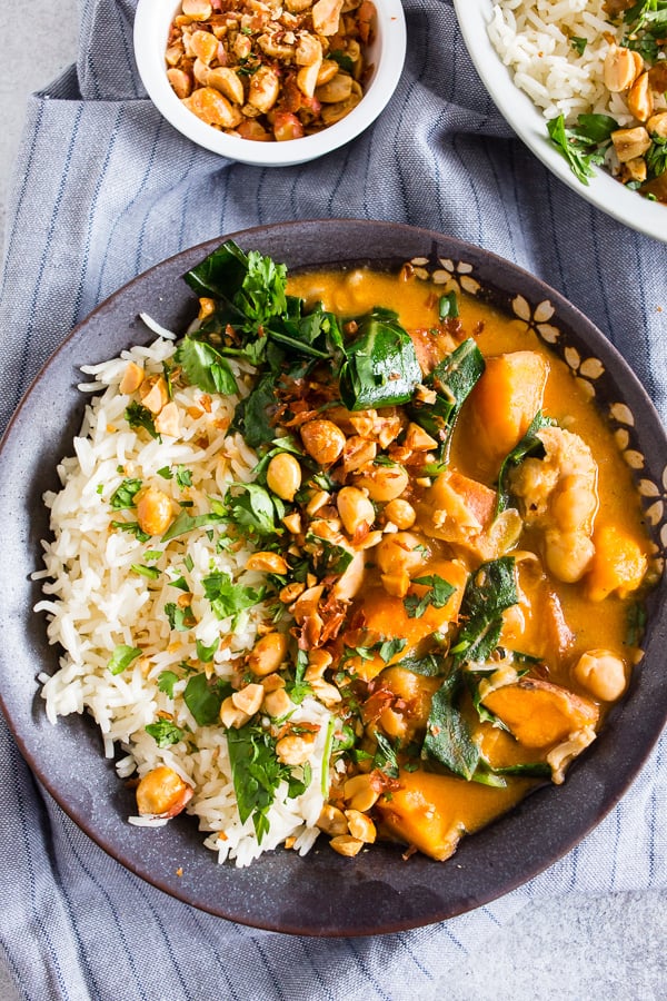 This African chicken peanut stew is packed full of chicken thighs, sweet potatoes, chickpeas, and collard greens simmering in a flavorful peanut butter and chicken stock broth. It's deliciously spicy and best served over rice and sprinkled with cilantro and crushed peanuts. This dish is hearty, full of flavor and ready in under an hour.