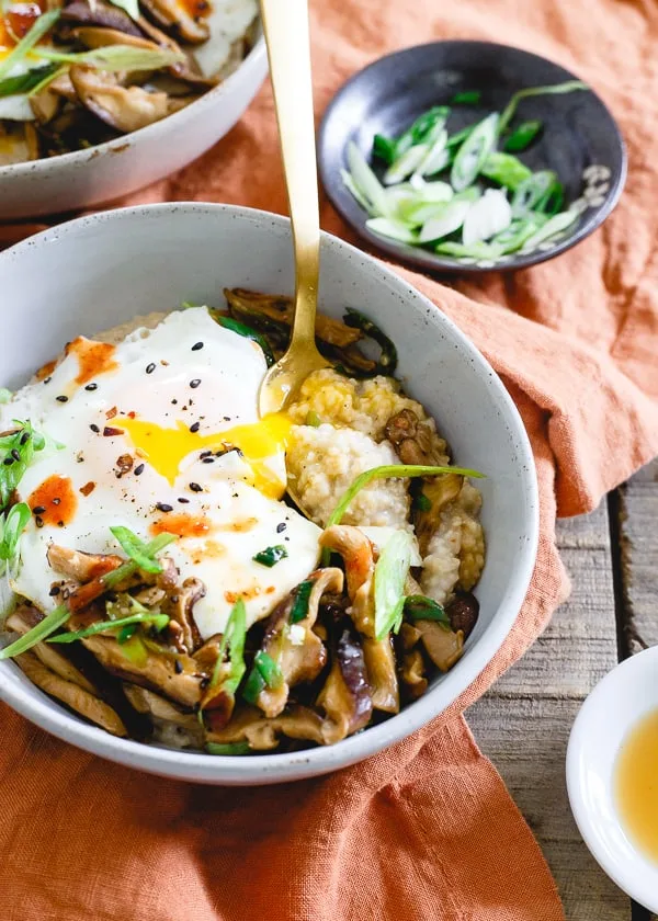 This savory Asian oat bran is simmered with spices and topped with sauteed shiitake mushrooms, fried eggs and garnished with sriracha. It's the perfect savory breakfast twist to traditional oat bran. Plus, not only does it make a great breakfast but it's also great for lunch or dinner! 