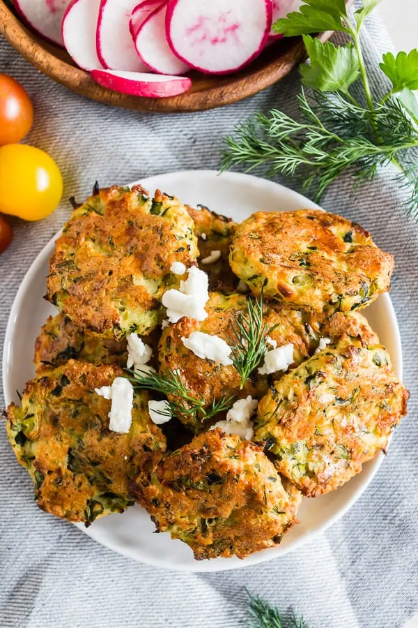 These Greek zucchini fritters are the perfect appetizer and vegetable filled dipper. Made with shredded zucchini, feta cheese and lots of fresh herbs. You'll love how easy they are to make and how easy they are to devour! 