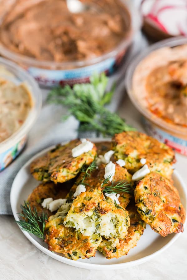 These Greek zucchini fritters are the perfect appetizer and vegetable filled dipper. Made with shredded zucchini, feta cheese and lots of fresh herbs. You'll love how easy they are to make and how easy they are to devour! 