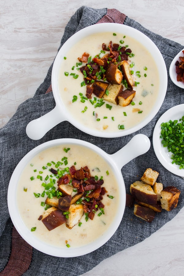 This spicy sharp cheddar beer soup is the perfect cheesy soup you need for cold spring nights. It’s slightly spicy with the addition of fresh jalapeno and pepper jack cheese with just the right splash of beer flavor and sharp cheddar. Perfect when topped with homemade soft pretzel croutons, fresh chives, and crispy bacon.