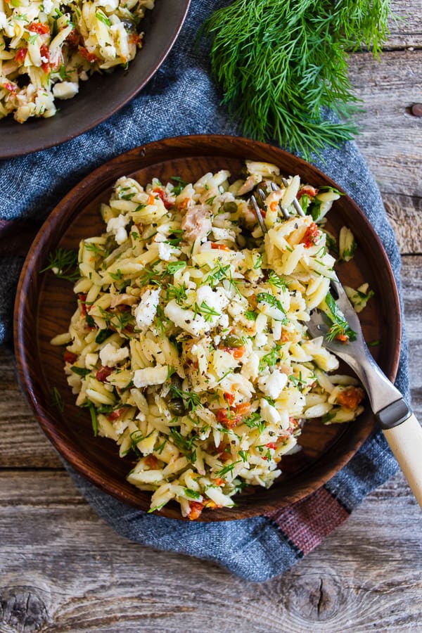 This Mediterranean tuna orzo salad is a great quick and easy weeknight meal. Protein packed tuna and orzo pasta mixed with lemon, capers, artichoke hearts, sundried tomatoes and lots of fresh herbs. You'll love this easy summertime meal! 