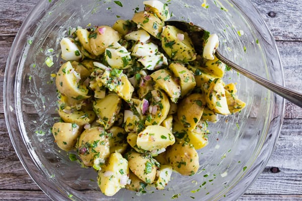 This honey mustard potato salad can be served warm or cold but the best part is that it's mayonnaise free, packed full of herbs and just the right amount of whole grain mustard and natural honey. It's a fun twist to traditional potato salad and you'll love the sweet and savory combination. 