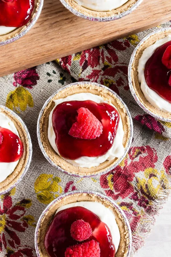 These no bake raspberry lemon mini cheesecakes are going to be your new favorite summer dessert. Lots of big time lemon flavor packed into a creamy cheesecake mixture and topped with raspberry jam and fresh raspberries. It's the perfect mixture of sweet and tart!