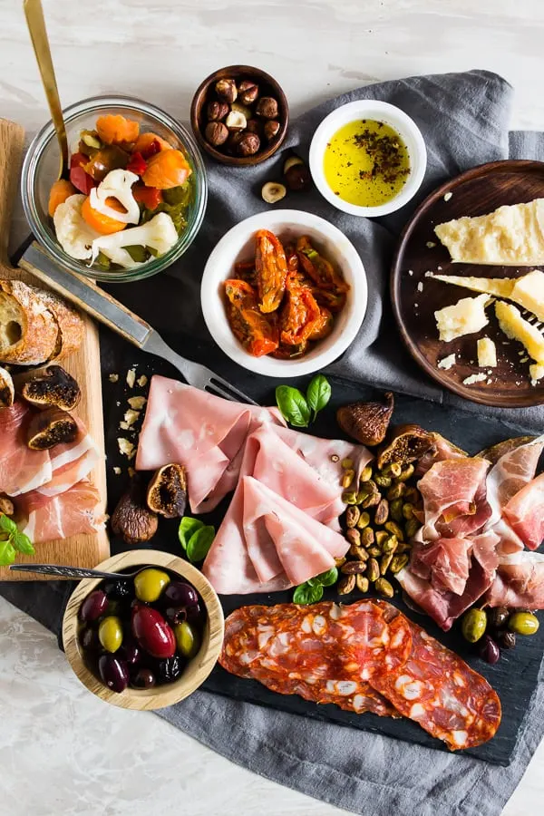 This Italian salumi board is the perfect combination of delicious imported Italian meats, imported Italian cheese, nuts, dried fruit, olives, roasted tomatoes, pickled vegetables and grilled bread. It makes a great appetizer or a simple summer meal - no cooking required! 