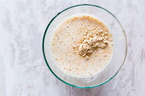 Overhead view of peanut butter protein shake in a glass.