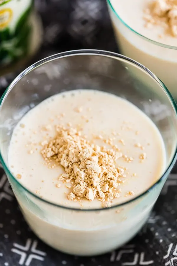 Close-up of peanut butter protein shake with peanut butter powder sprinkled on top.