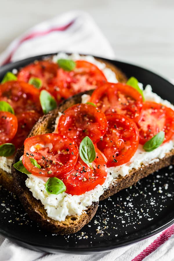 tomato ricotta toast sprinkled with salt and pepper. 
