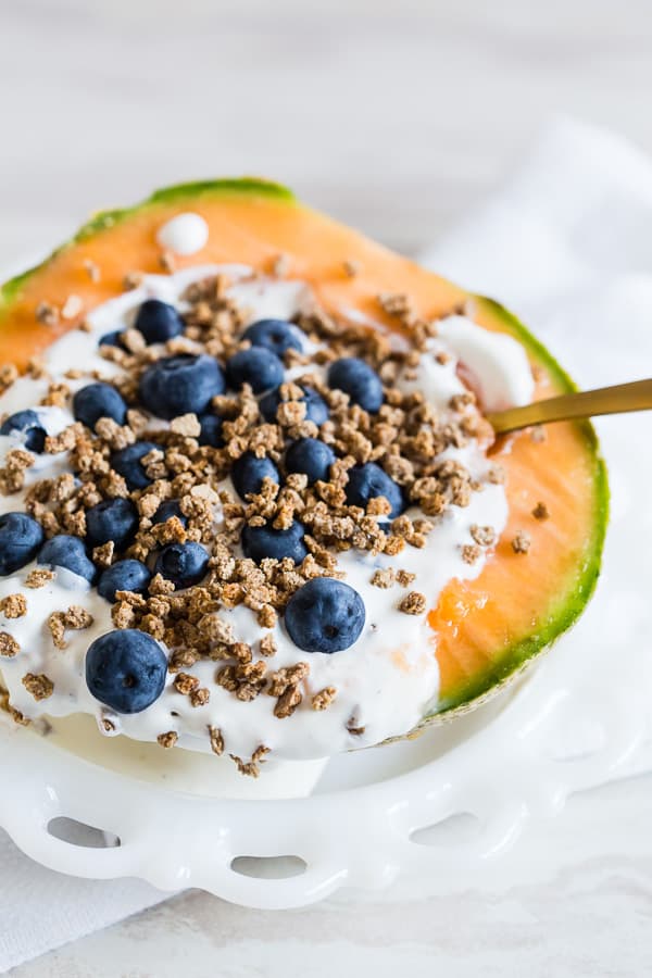 Crunchy Yogurt Cantaloupe Breakfast Bowl served with Grape Nuts and blueberries. 