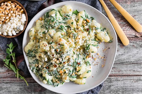 This creamy gorgonzola gnocchi with baby spinach is topped with toasted pine nuts and just a sprinkle of Parmesan cheese. It’s the perfect creamy dish for Meatless Monday or throw on a little grilled steak to take it to a whole new level of protein packed deliciousness. Trust me, you’ll love how easy it is to make this flavorful dish!