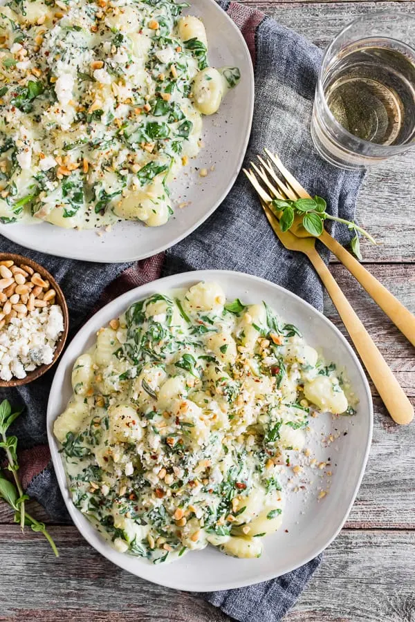 creamy gorgonzola gnocchi on two plates. 