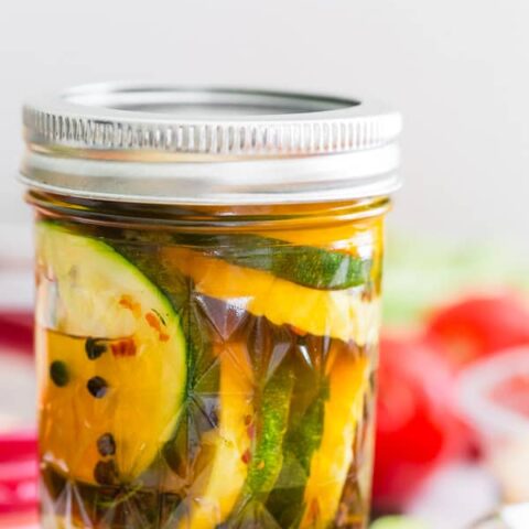 sweet and spicy zucchini pickles in a glass canning jar